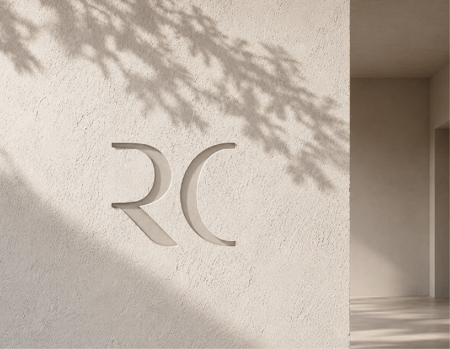 Logo RC de Errece grabado en muro con sombra de hojas